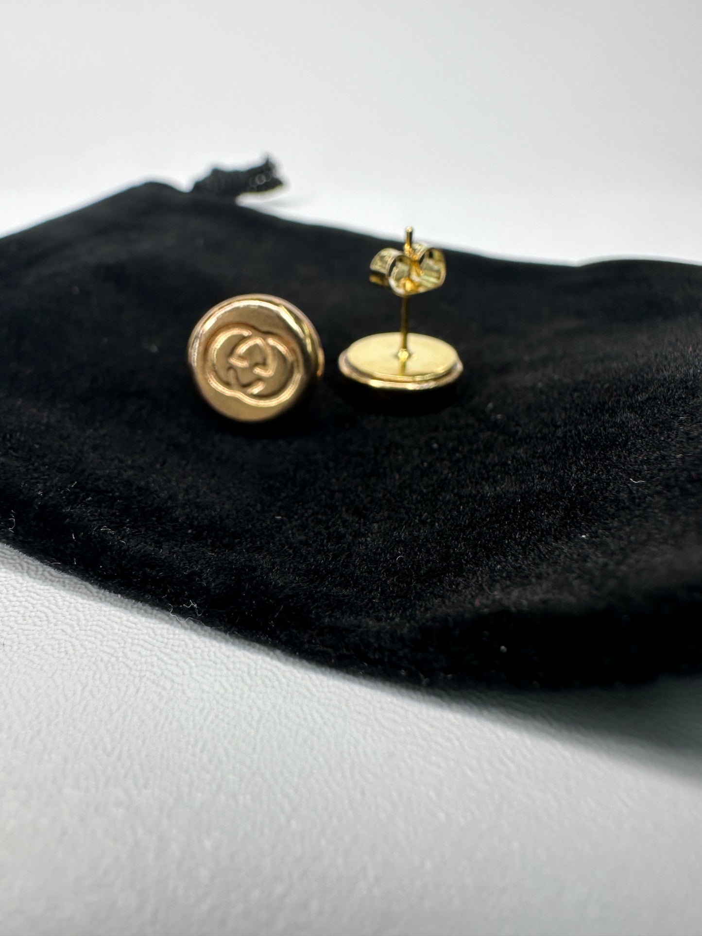 Upcycled gucci earrings from luggage rivets